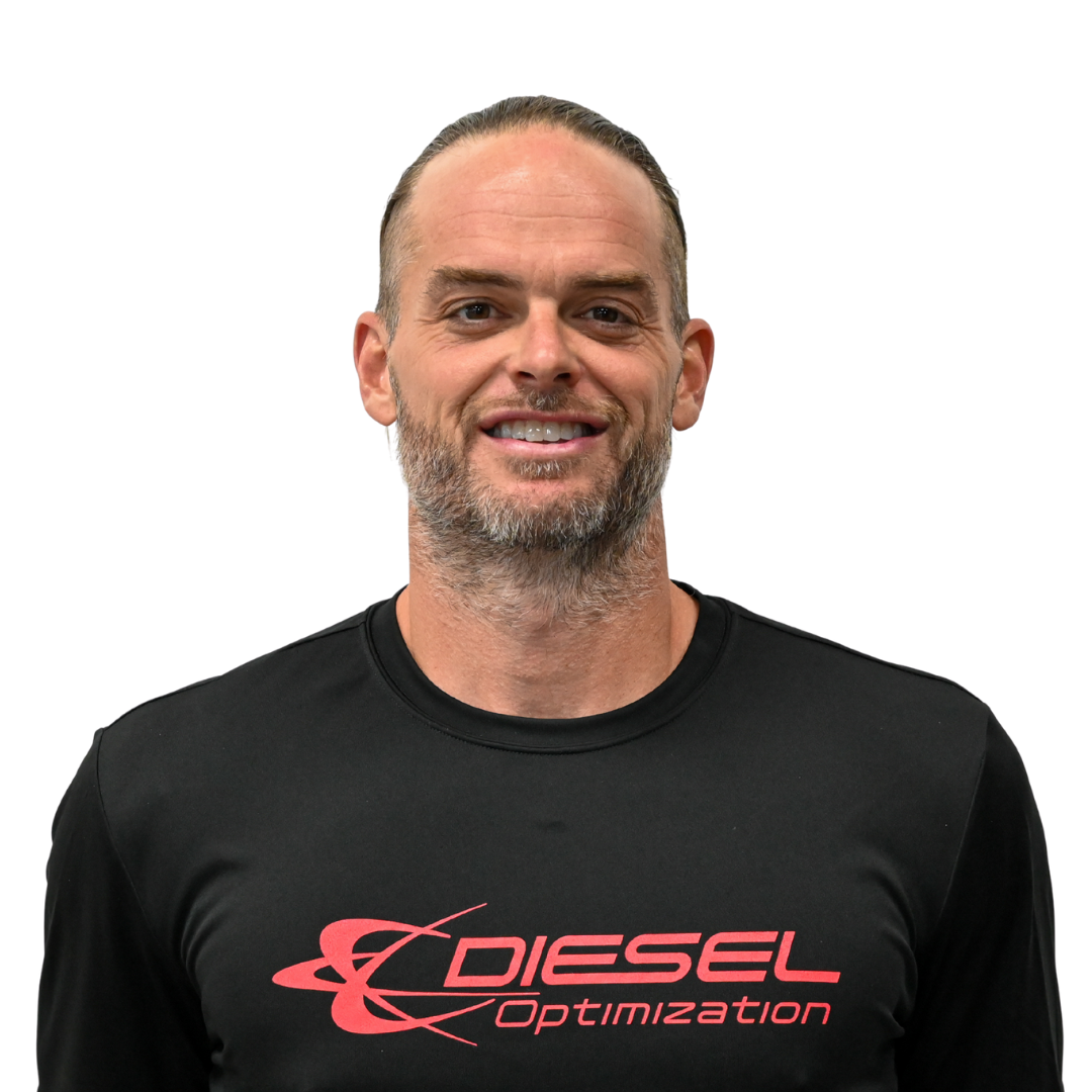 Man with long hair and beard smiling, wearing a 