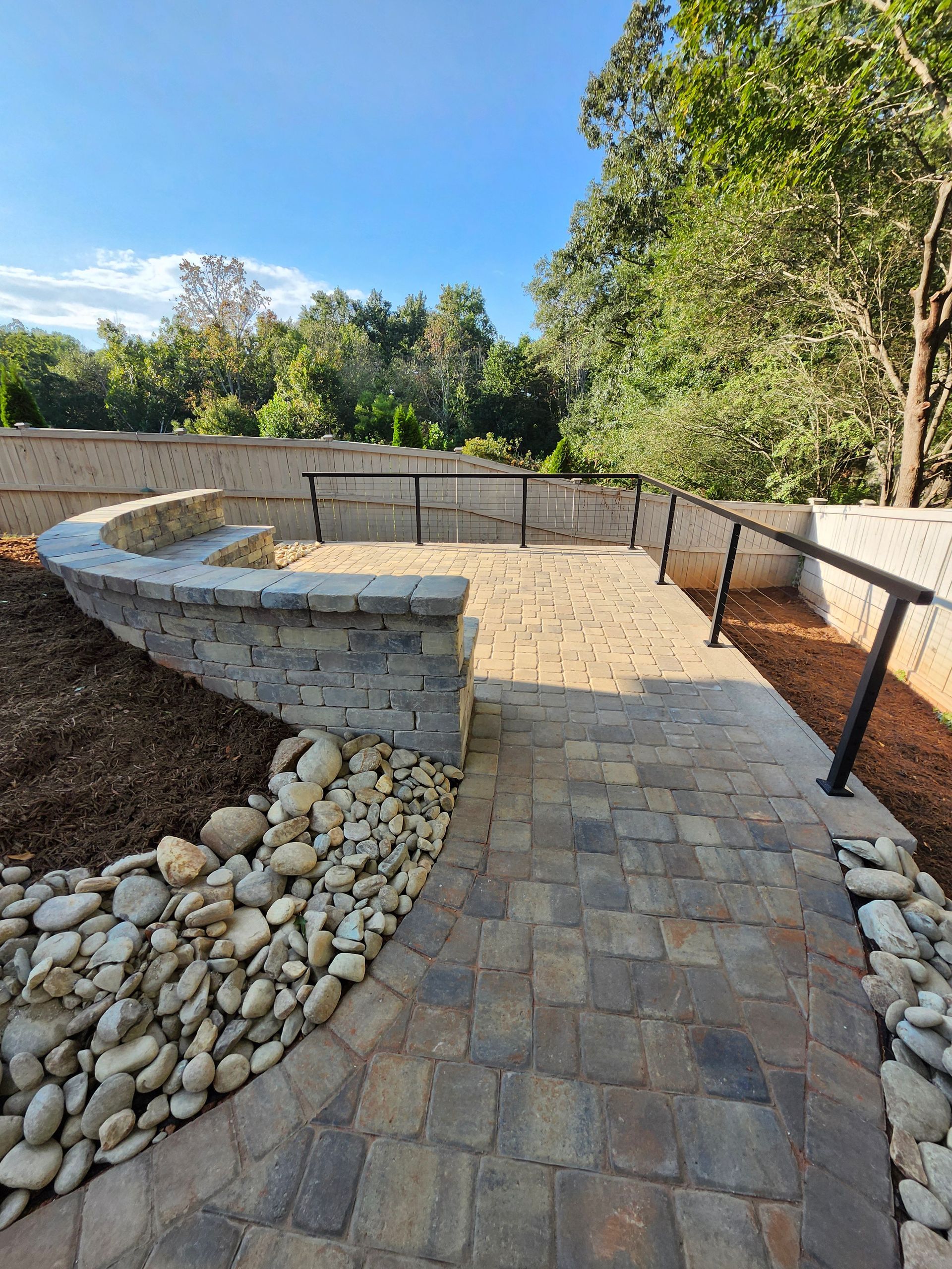 A patio is being built in the backyard of a house.