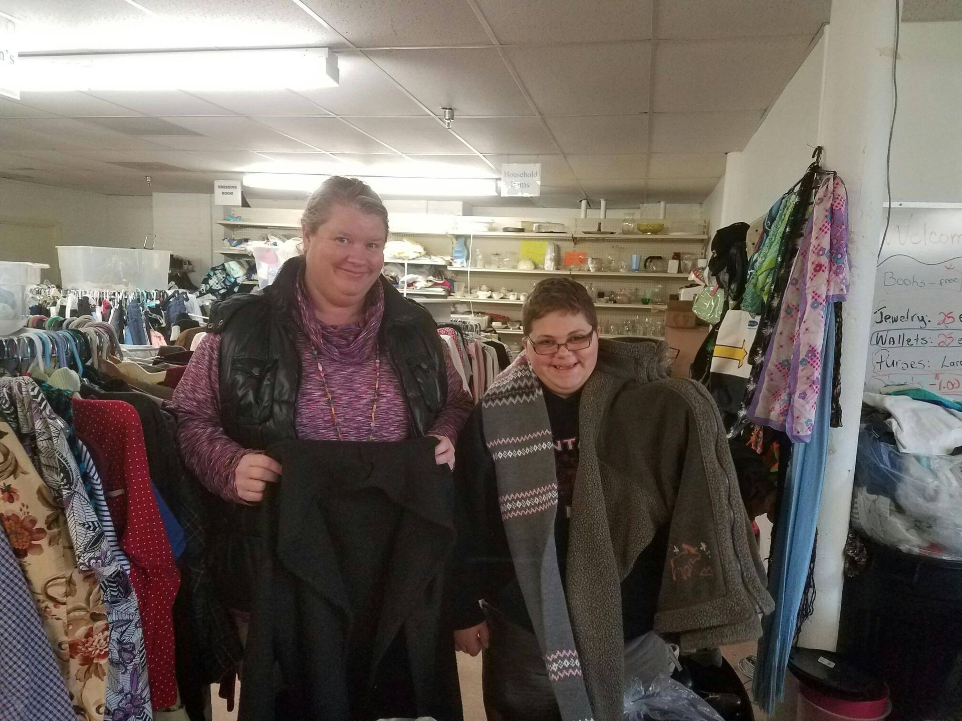 Two women are standing next to each other in a clothing store