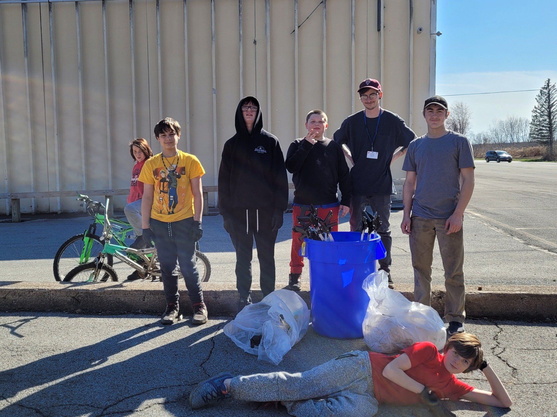 A group of young people are standing in front of a building.