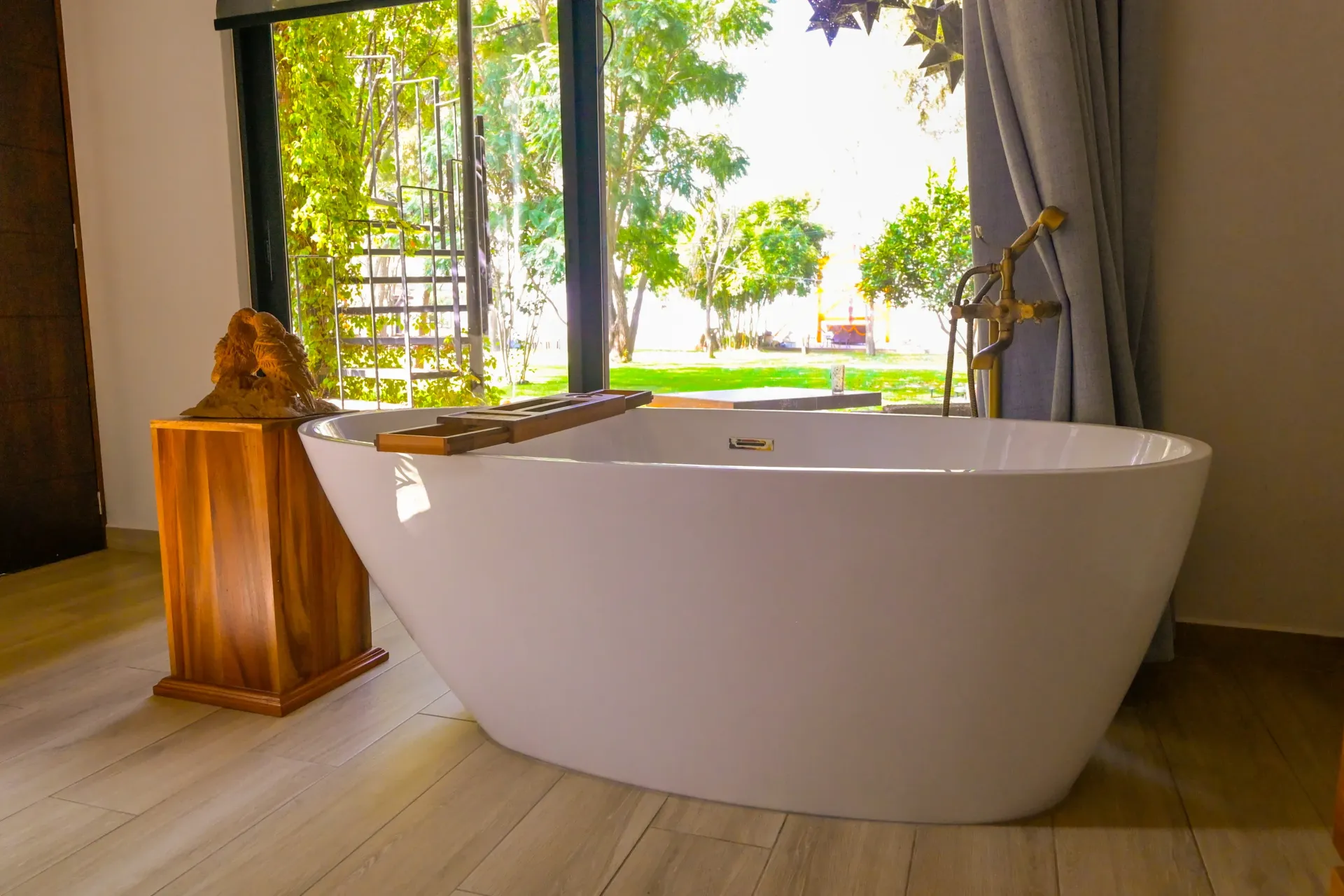 A bathtub is sitting in a bathroom next to a window.