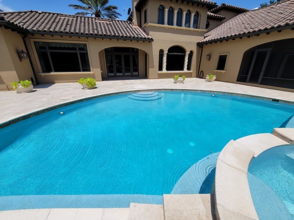 A large house with a swimming pool in front of it