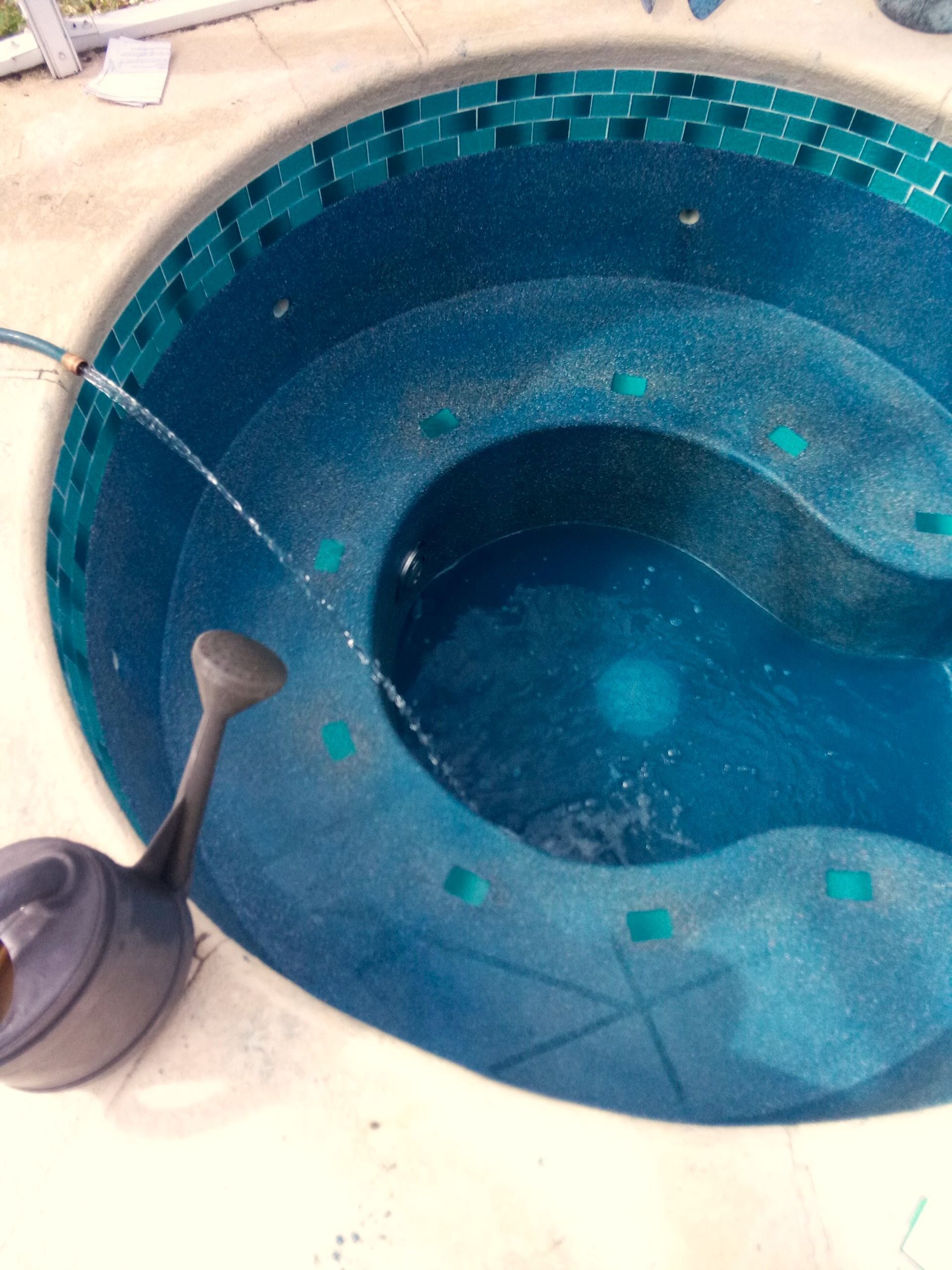 A hot tub with a hose coming out of it