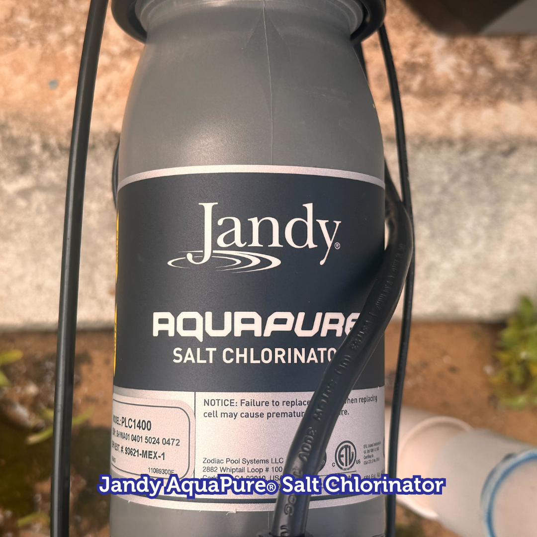 Jandy AquaPure salt chlorinator with black and grey colors attached to piping.