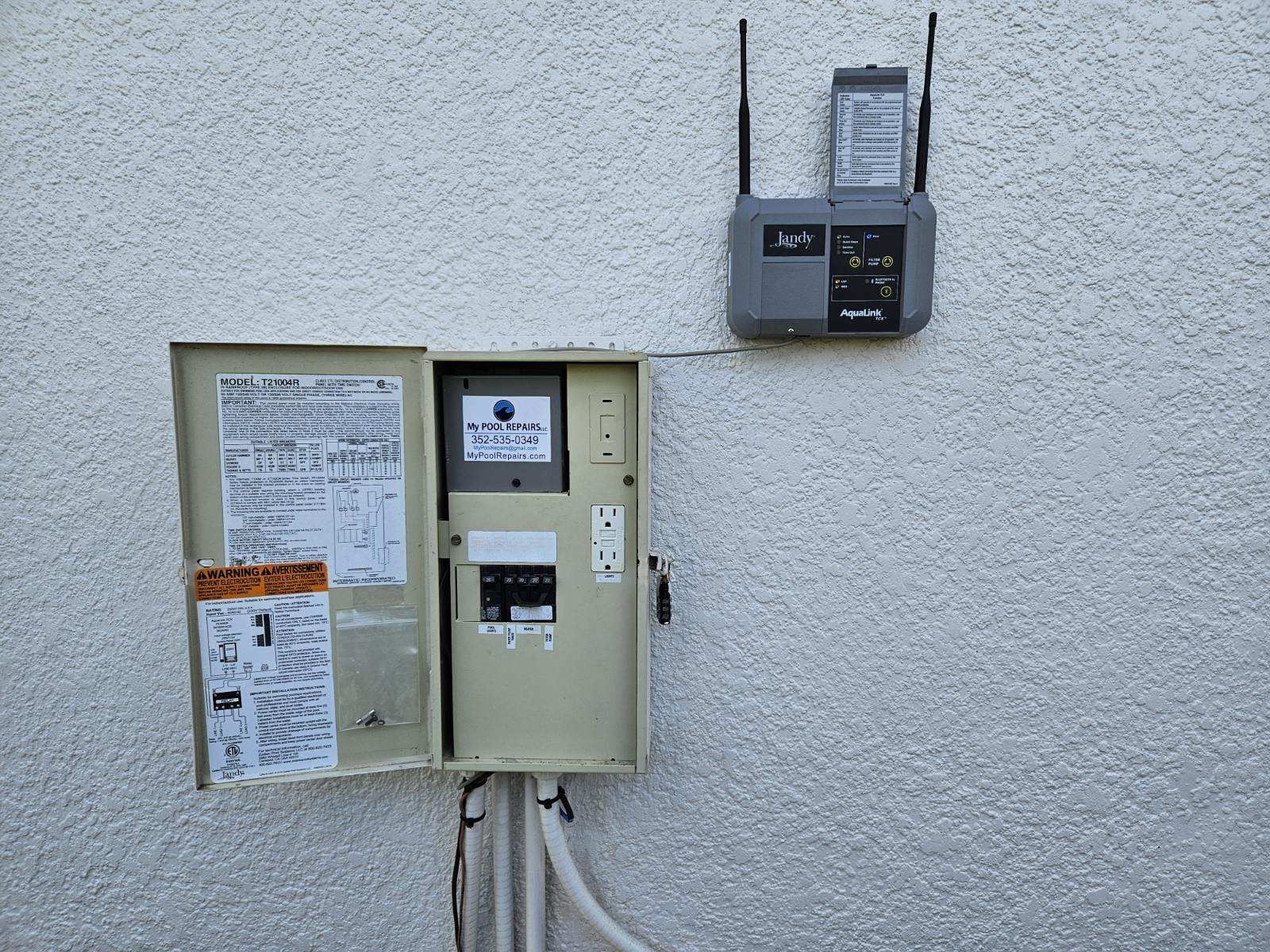 A white wall with a box and a meter on it.