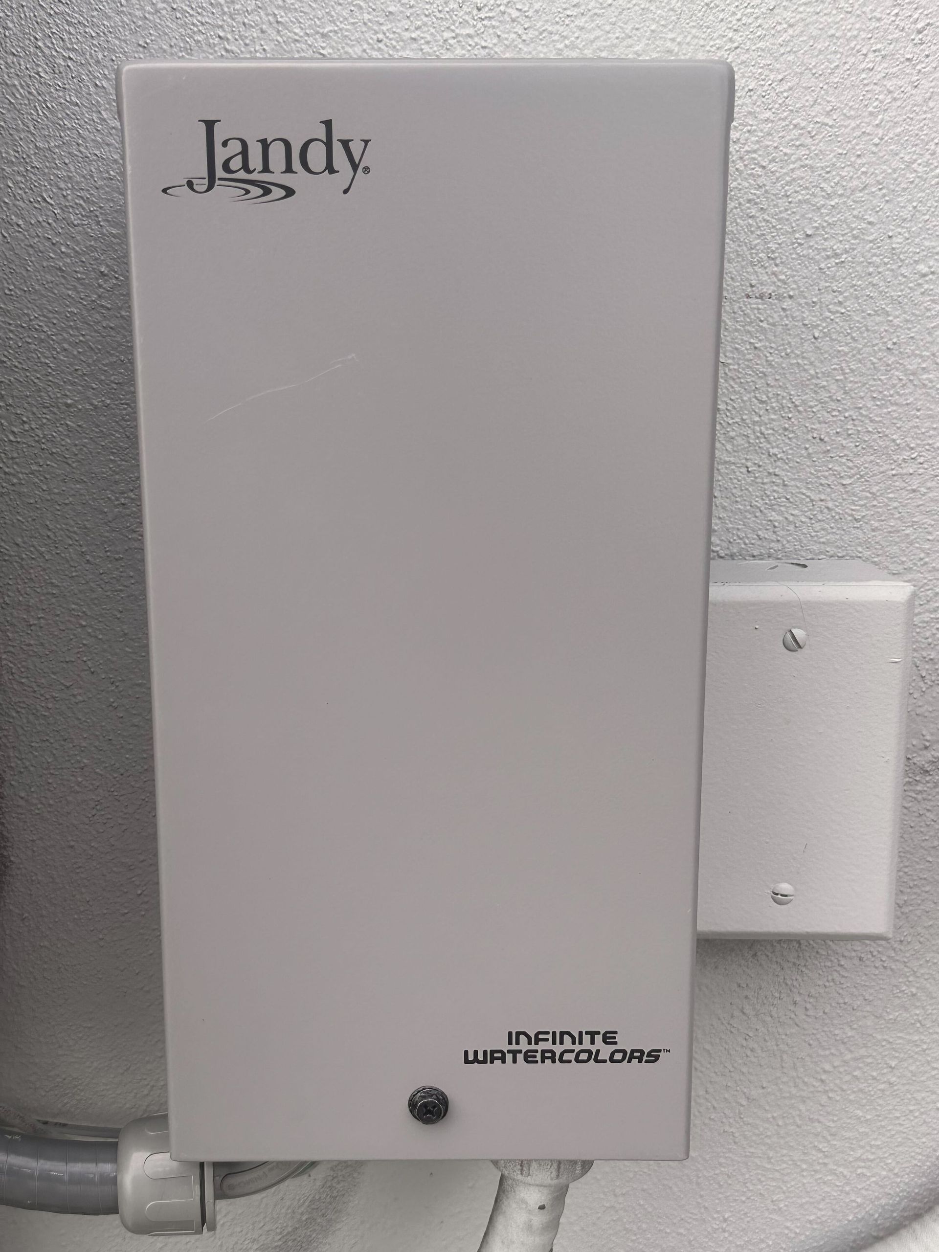 Jandy pool control box on a wall, labeled 