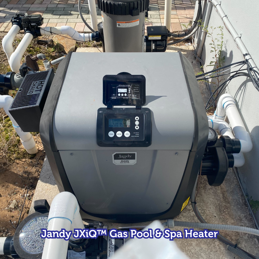 Jandy JXiQ gas pool & spa heater with control panel and white pipes. Gray and black exterior.