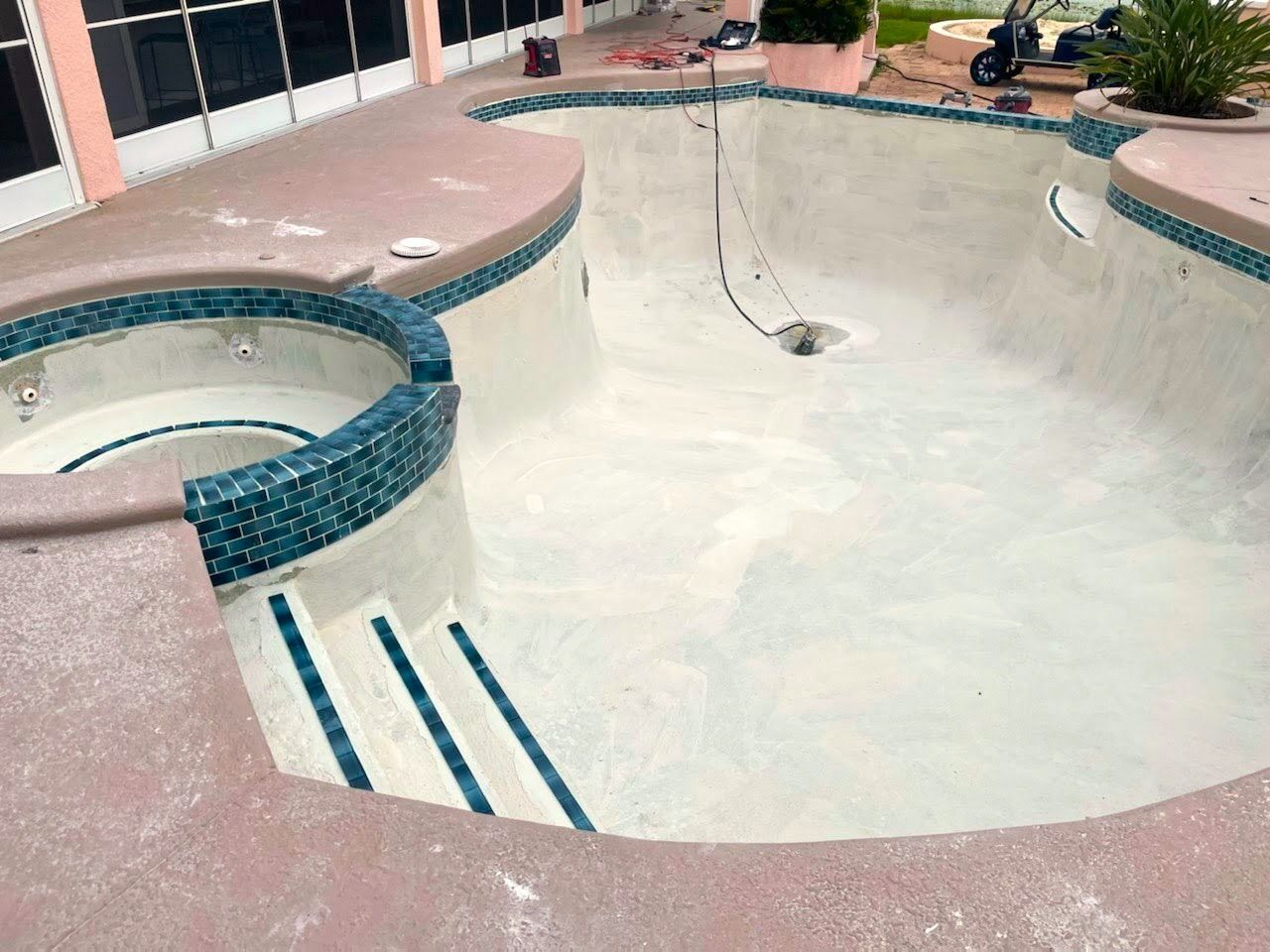 A large swimming pool with a hot tub in the middle