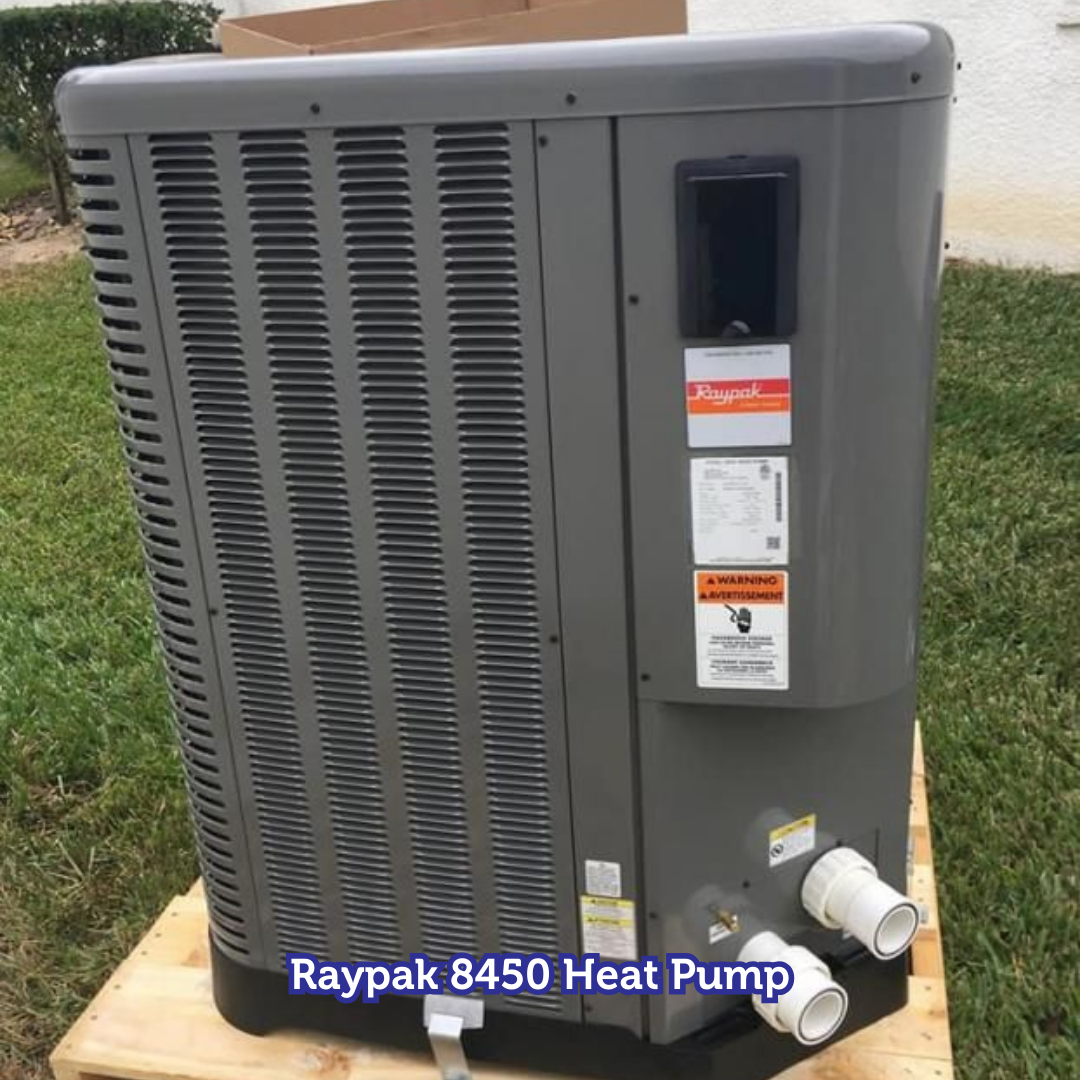 Raypak 8450 heat pump on a wooden pallet outdoors. Gray unit with vents, pipes, and labels.