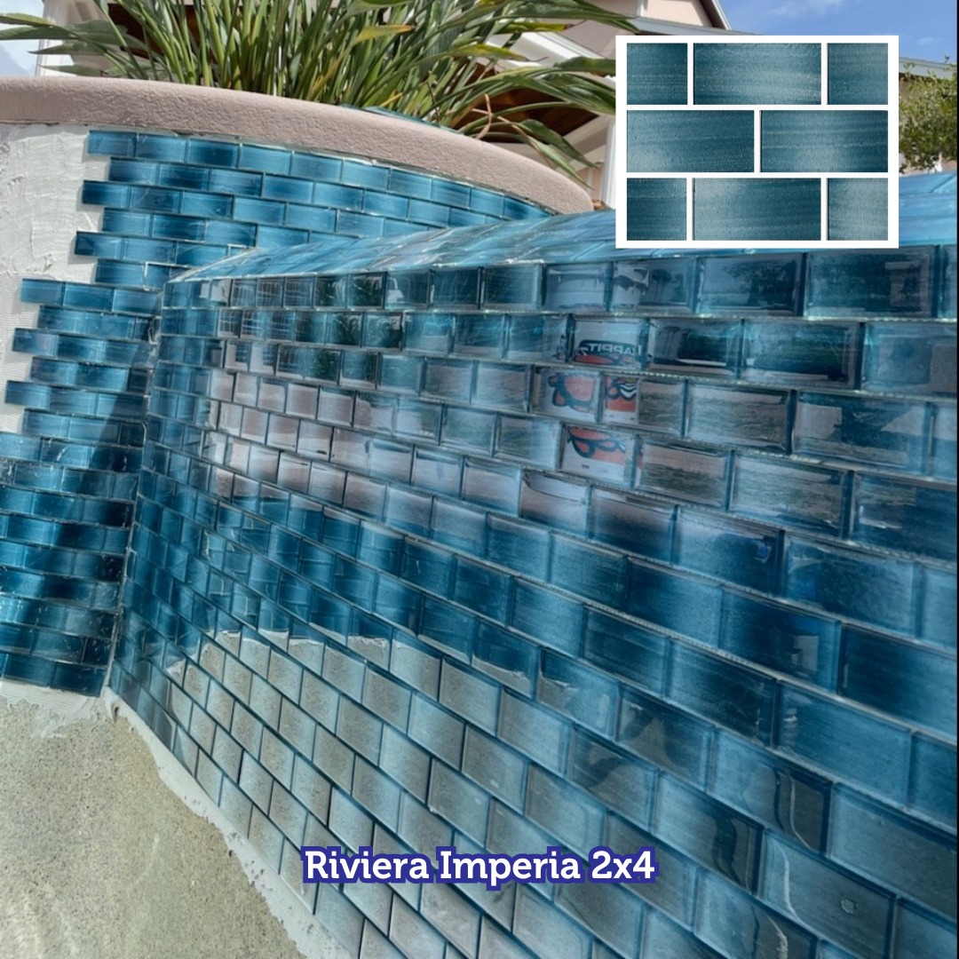 Blue glass mosaic tile installation on curved pool wall.