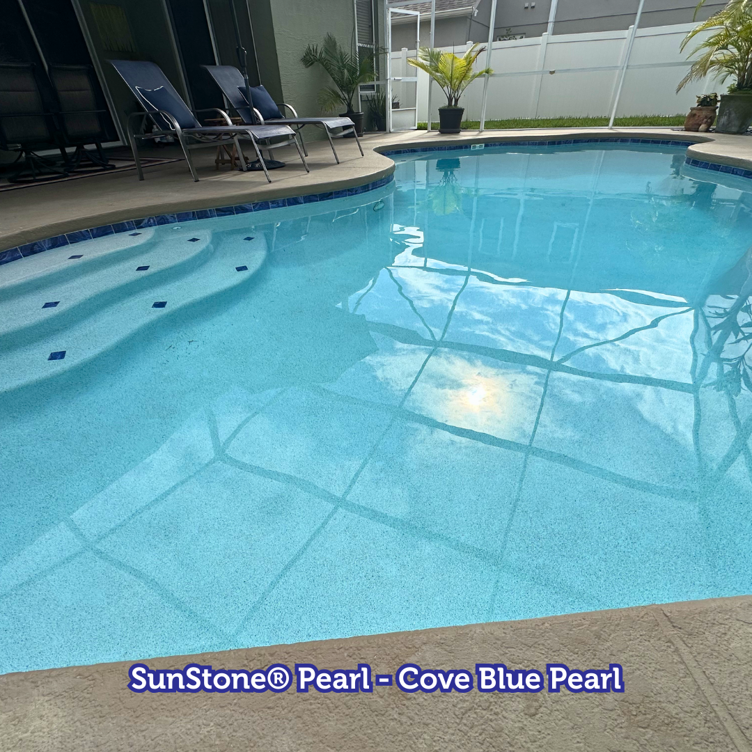 Pool with blue tile and steps, featuring reflective water and blue-toned pebble surface.