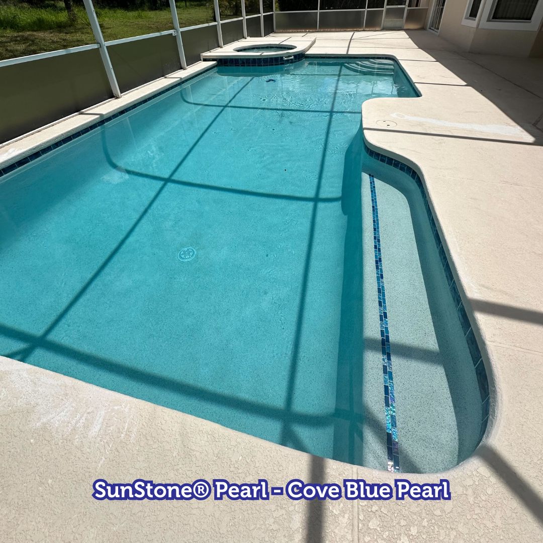 Swimming pool with Cove Blue Pearl finish, surrounded by a light-colored patio.