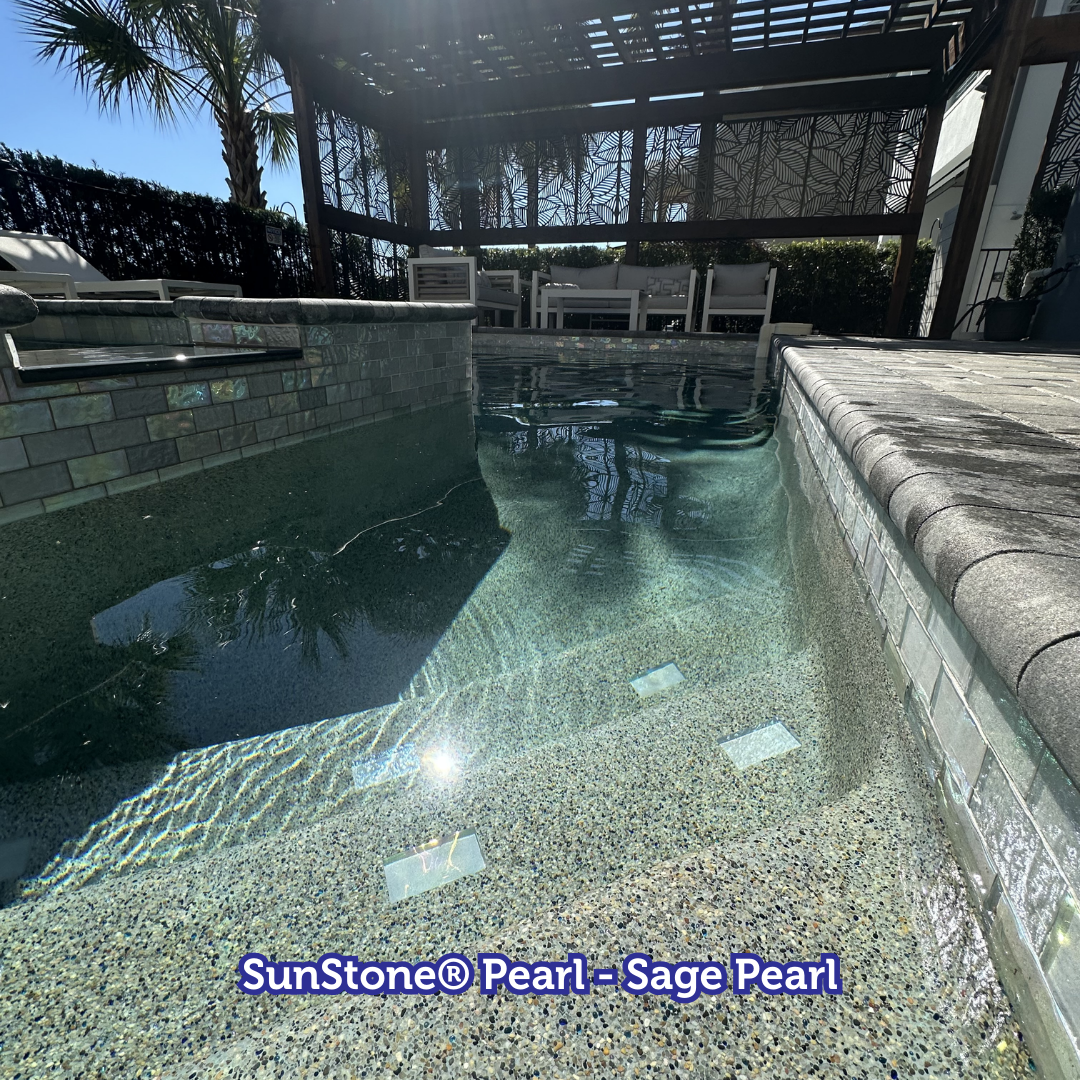 Pool with sage pearl tile, steps, and a pergola overhead.
