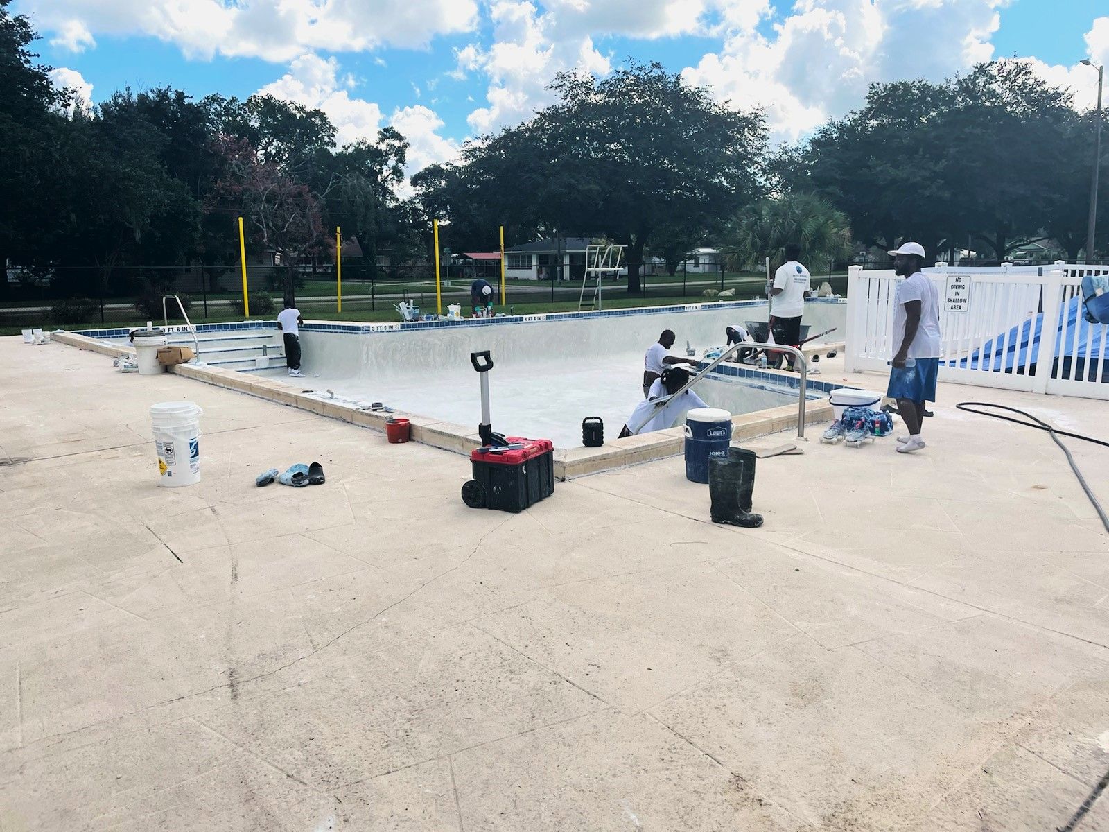 A group of people are working on a swimming pool.
