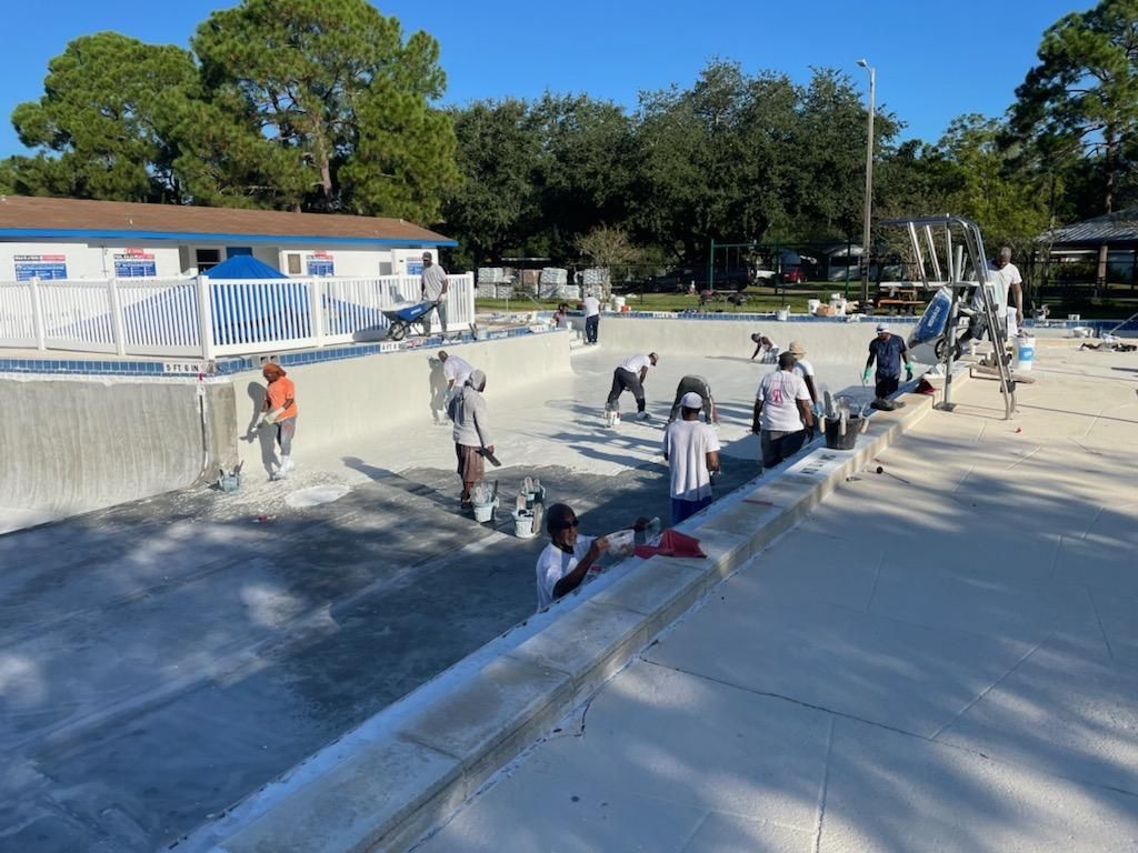 A group of people are working on a swimming pool.