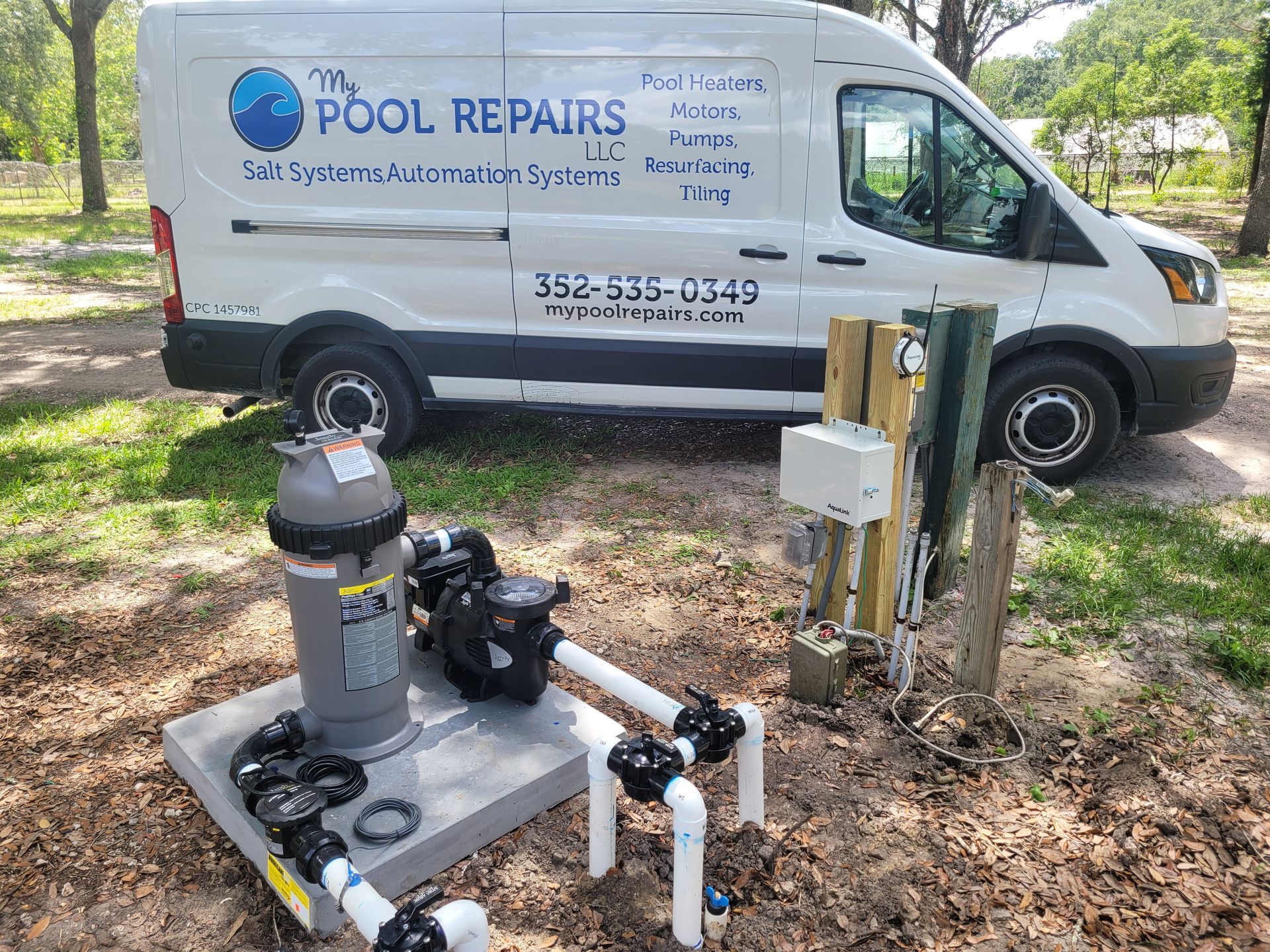 A white van is parked next to a swimming pool pump.