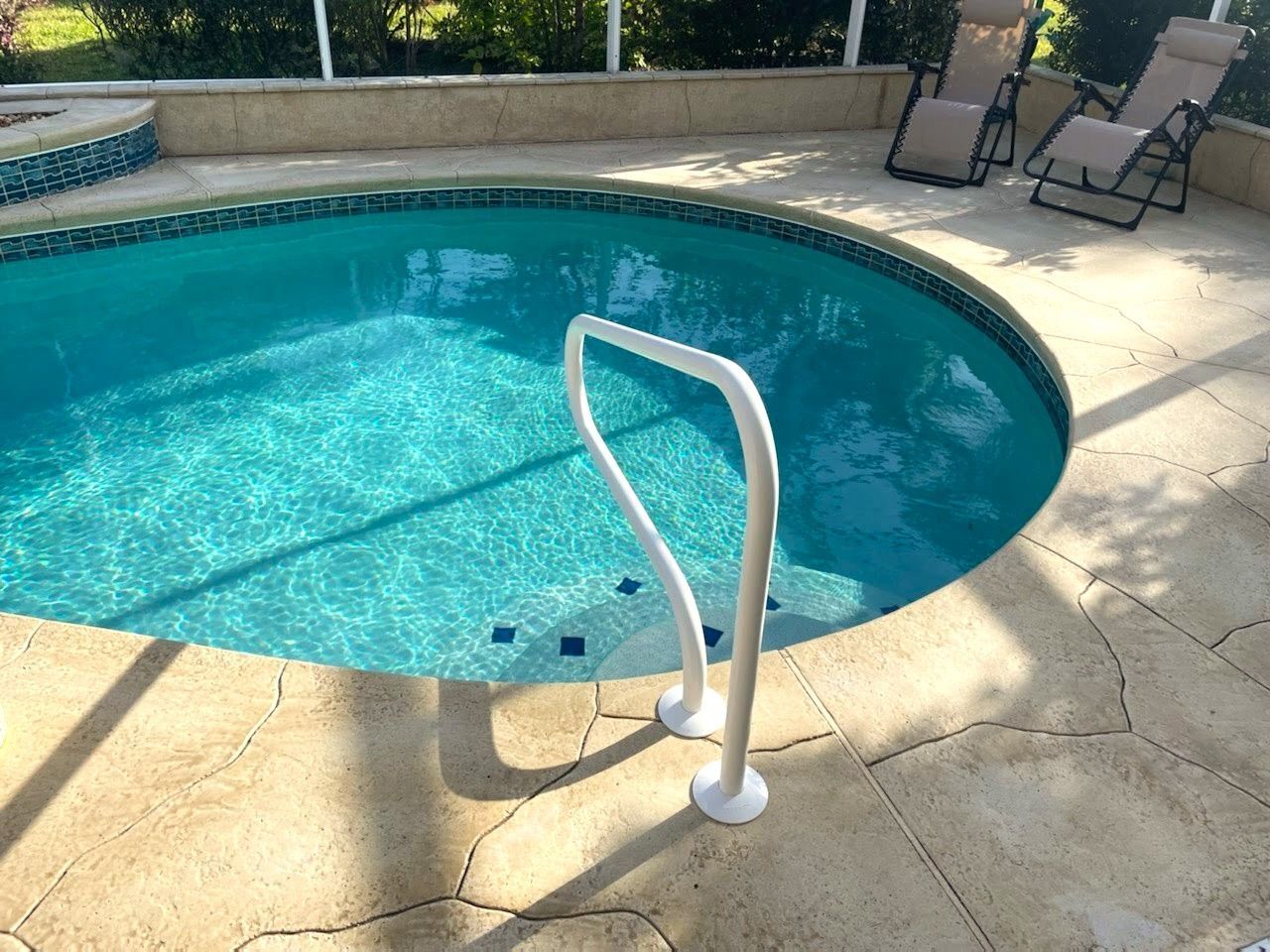 A swimming pool with a white railing leading to it