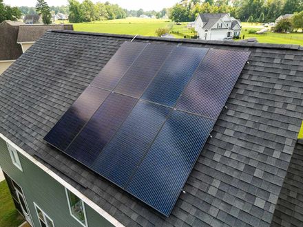 Solar panels installed on a dark asphalt shingle roof