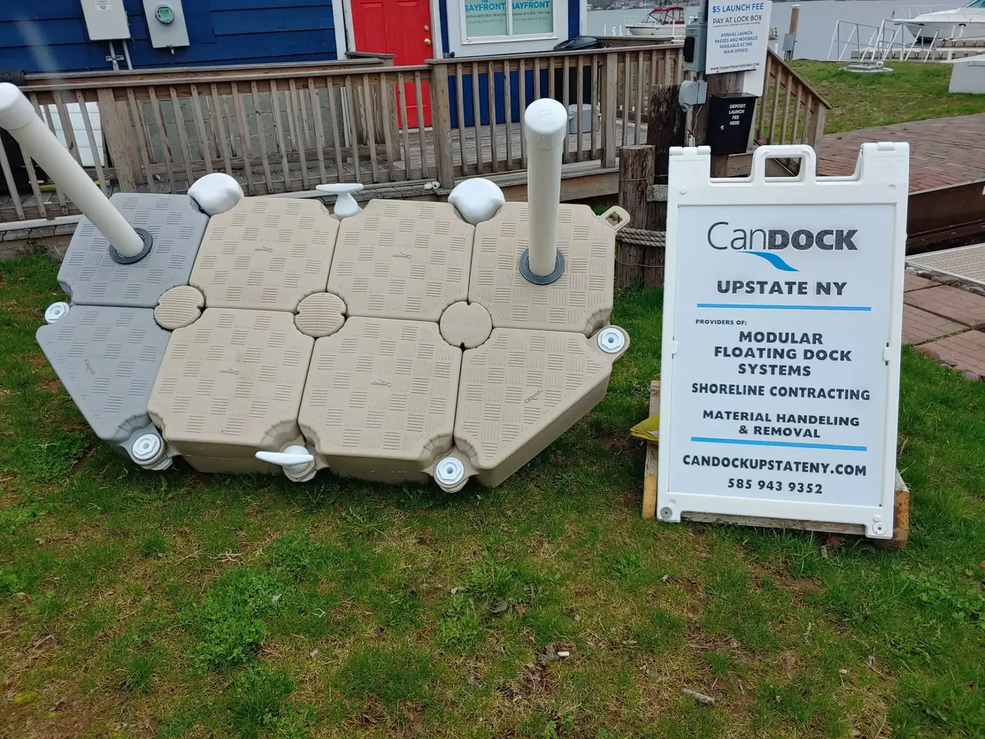 Outdoor Lubbock sign display beside a beige woven platform with white posts and spherical lights