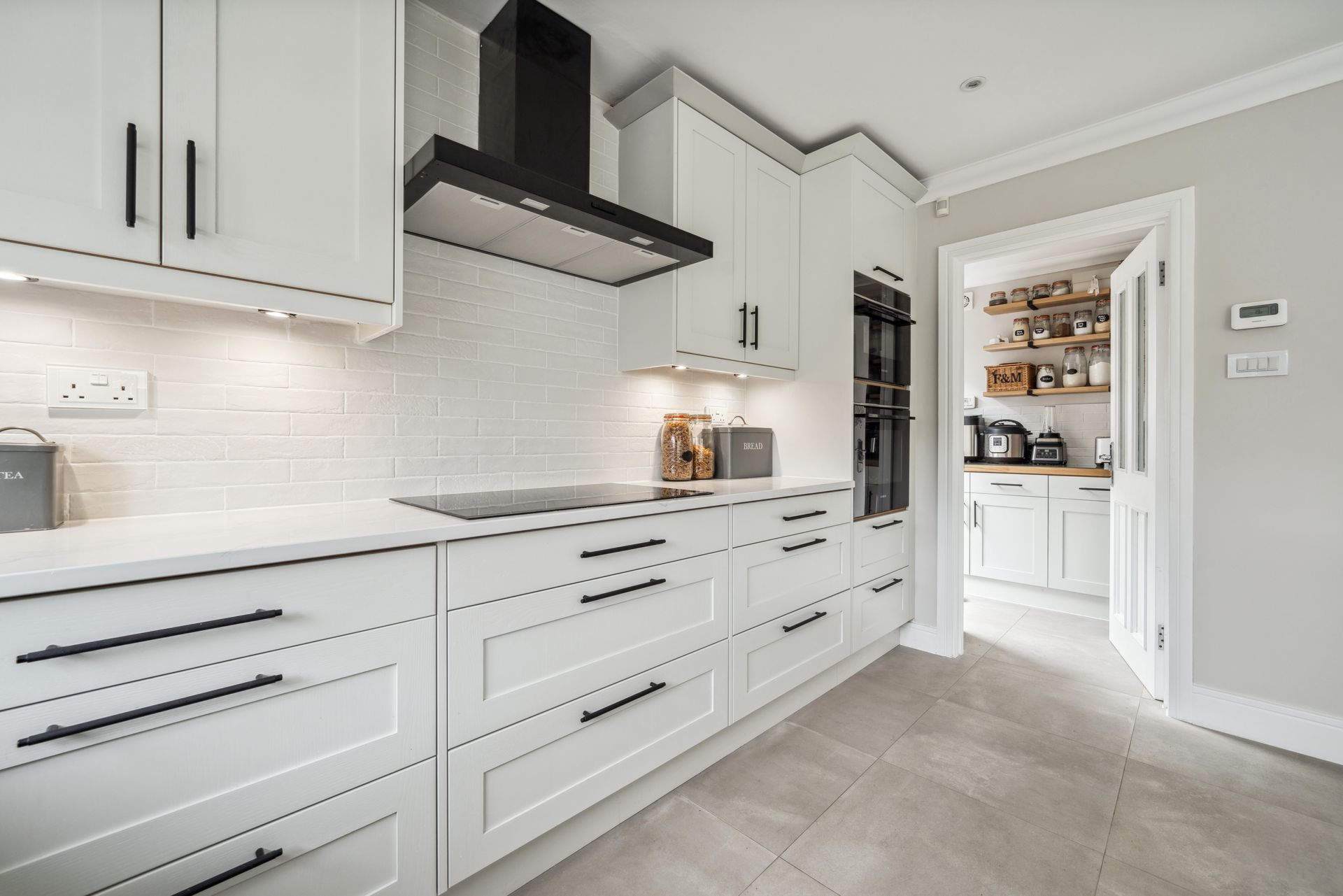 Modern kitchen with white cabinets and white worktop