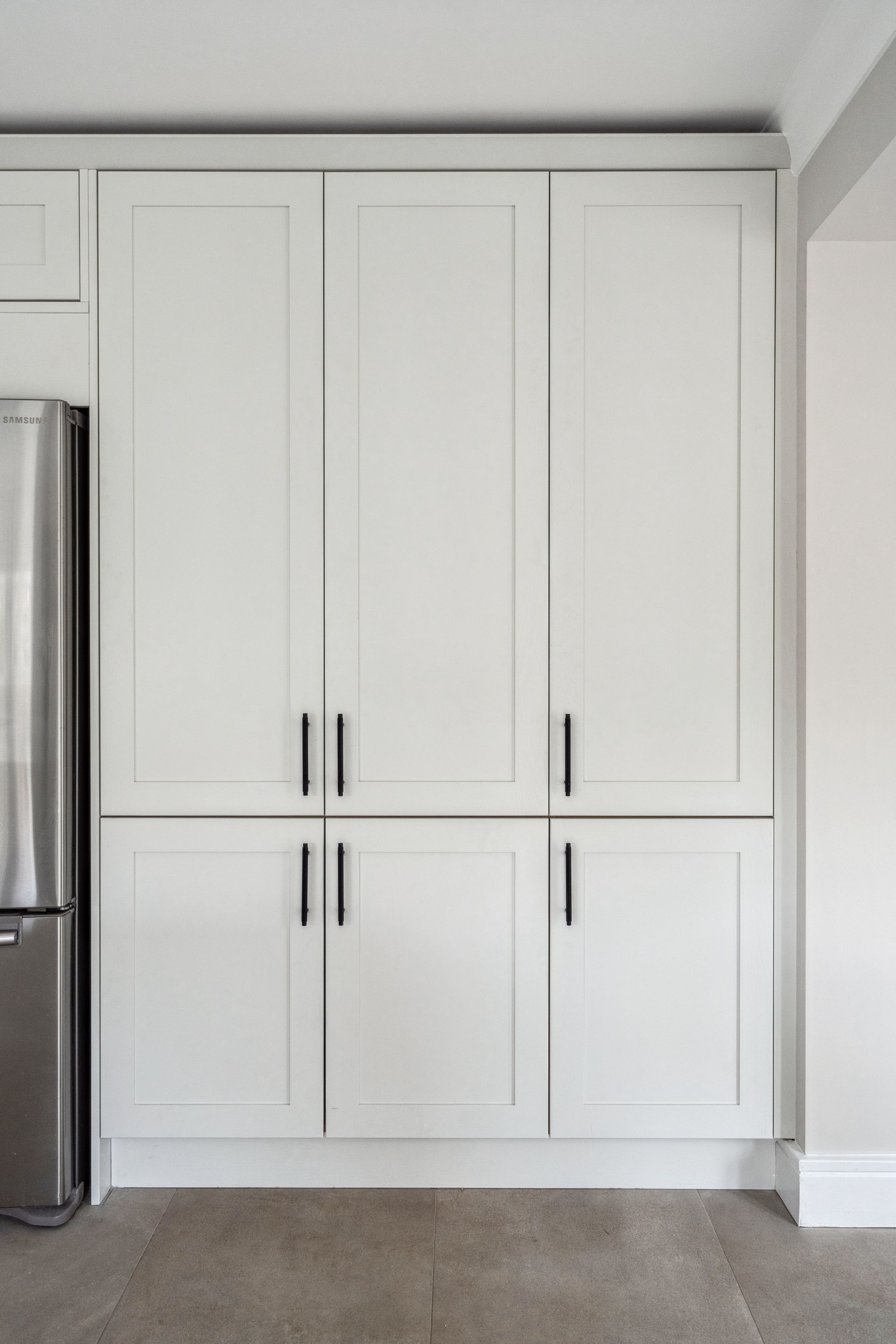 Modern kitchen with white cabinets and white worktop