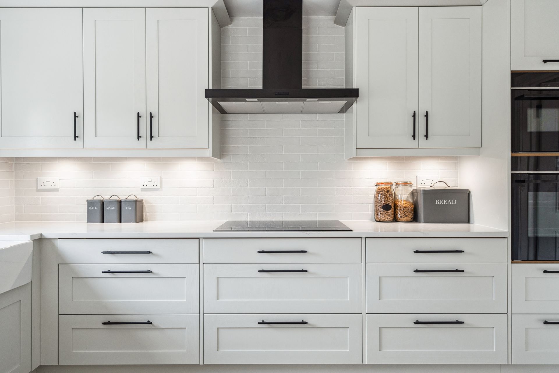 Modern kitchen with white cabinets and white worktop
