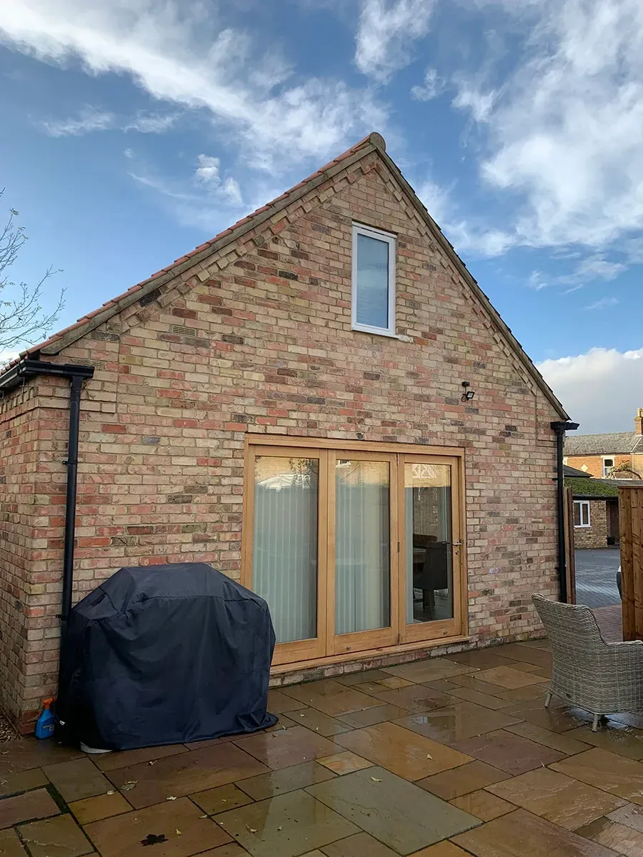 A large brick building with a patio in front of it.