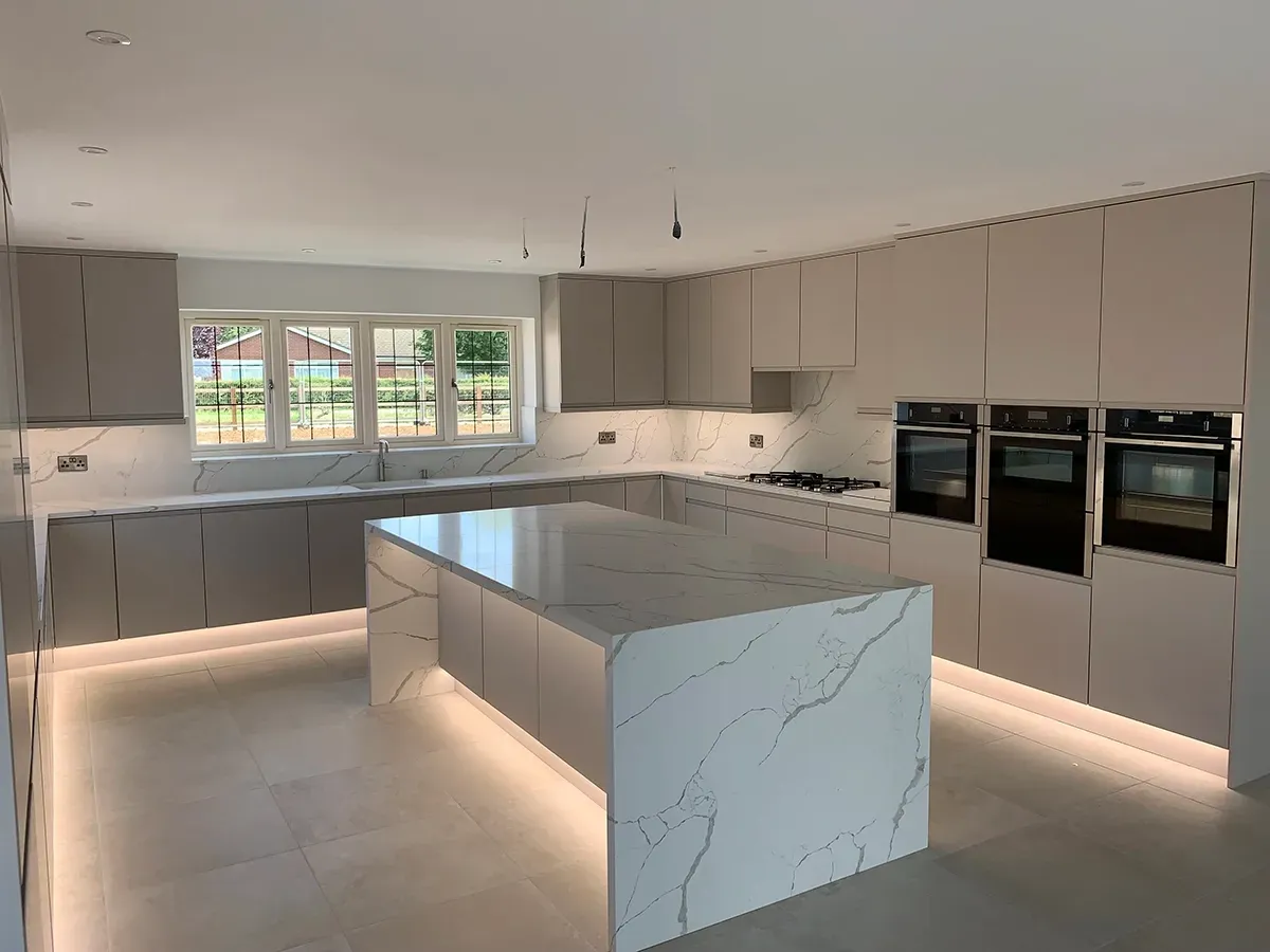 There is a large island in the middle of the kitchen.