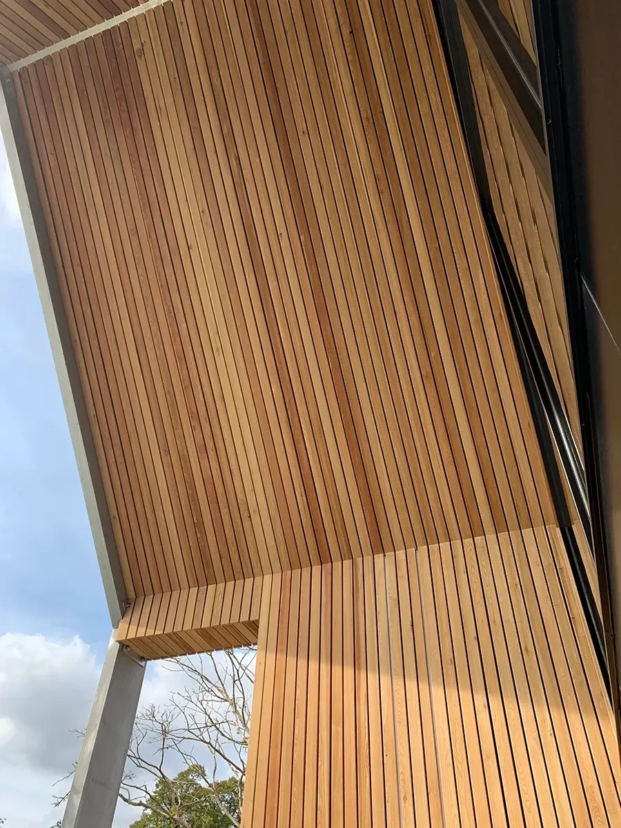 A close up of a wooden wall with holes in it.