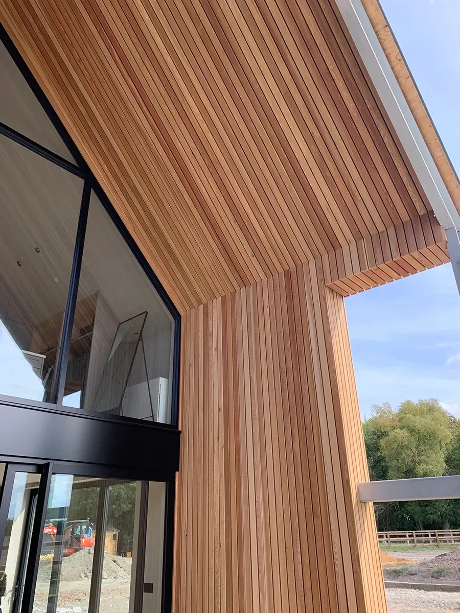 A building with a lot of windows and a wooden ceiling.