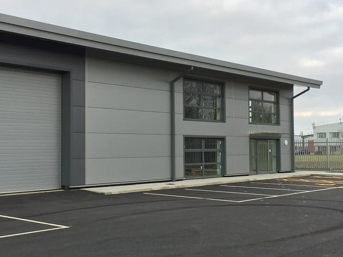 A large building with a lot of windows and a garage door.