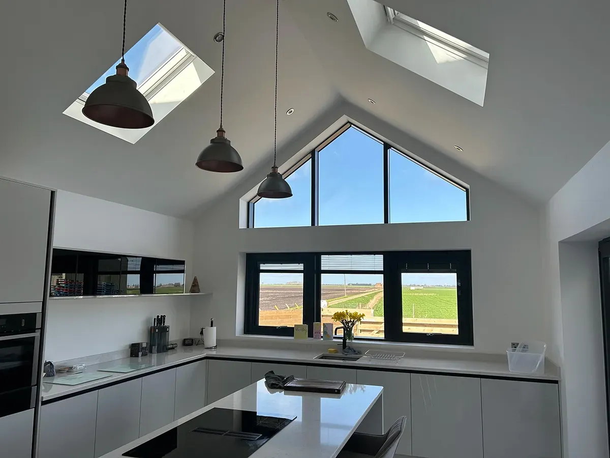A kitchen with a lot of windows and a skylight