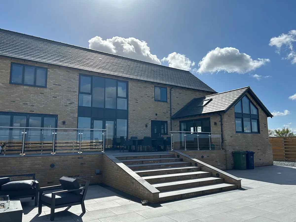 A large brick house with stairs leading up to it