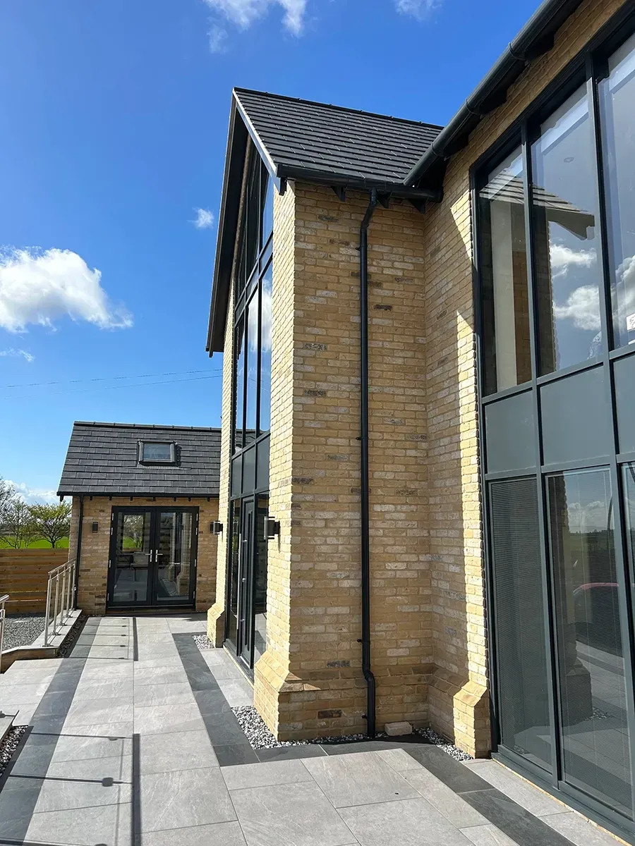 A large brick building with a lot of windows and a blue sky in the background.