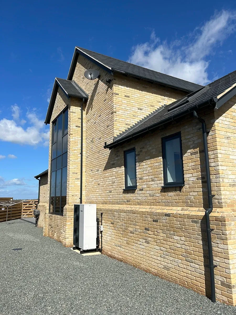 A large brick building with a blue sky in the background.