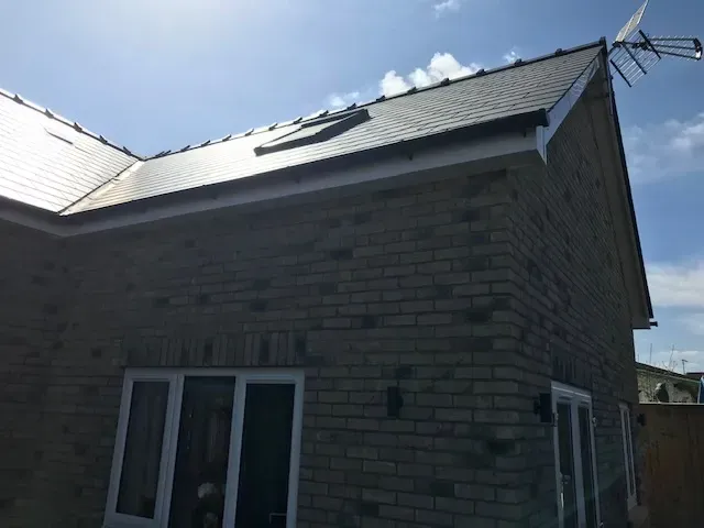 A brick house with a skylight on the roof