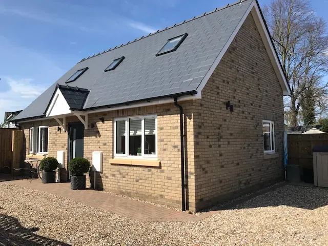 A small brick house with a slate roof