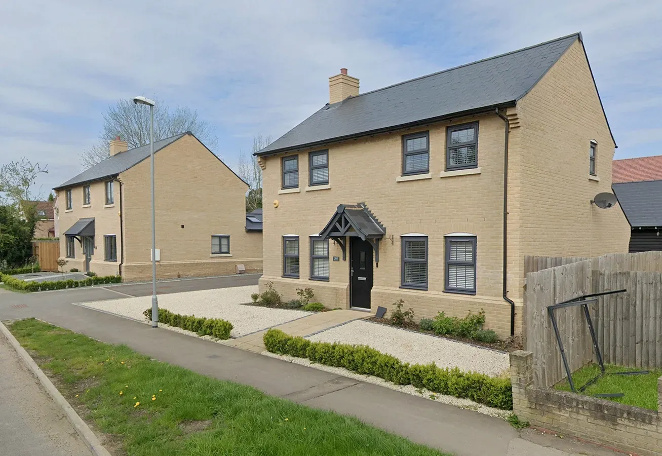 Two houses are sitting next to each other on a residential street.