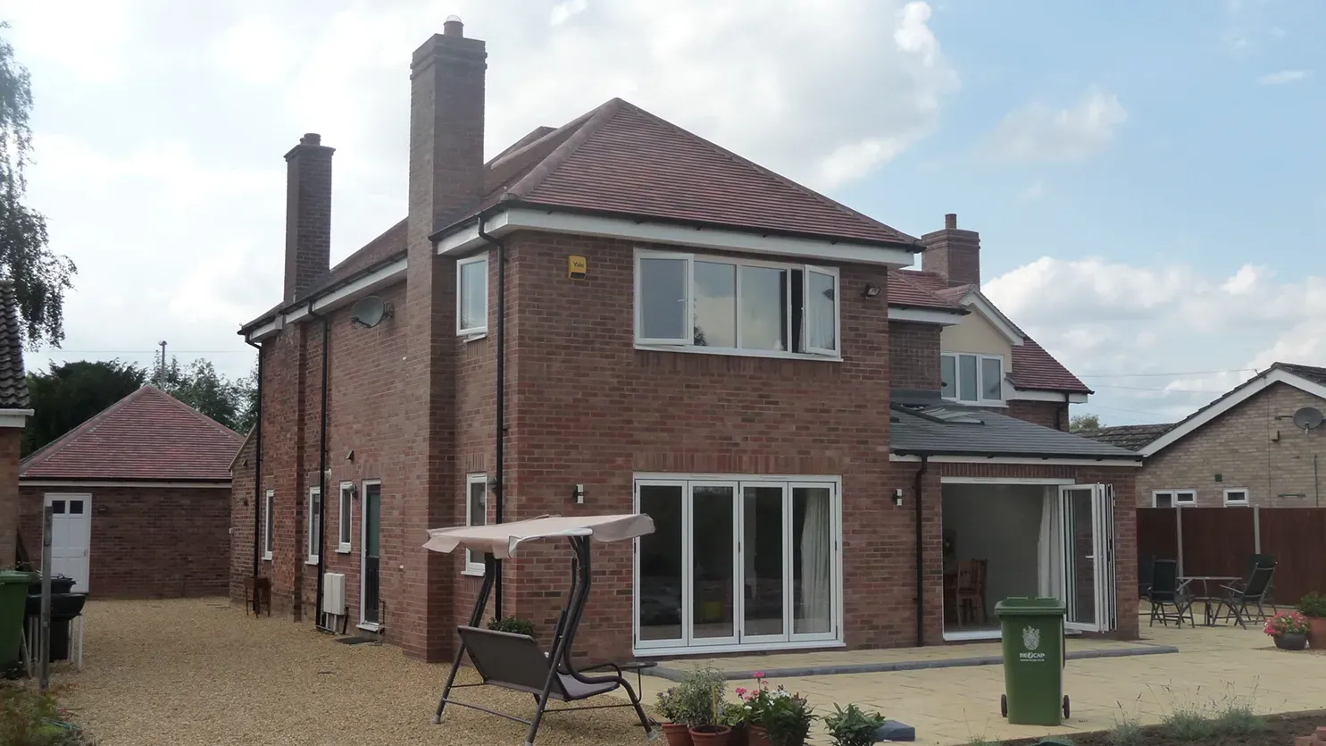 A large brick house with a red tiled roof