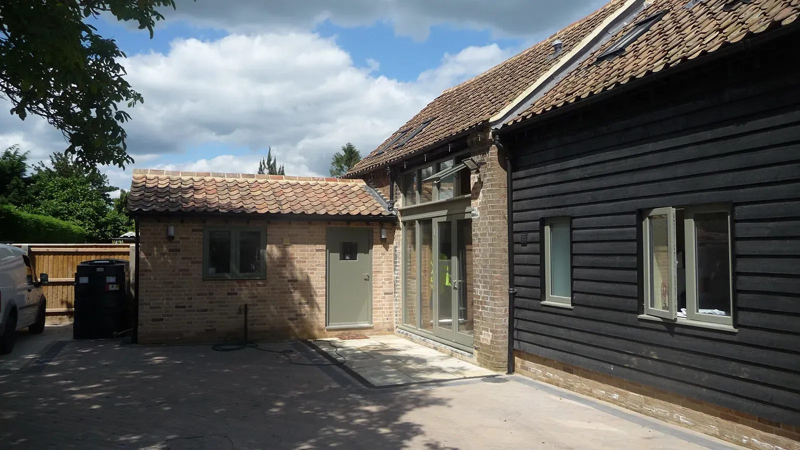 A house with a lot of windows and a brick wall