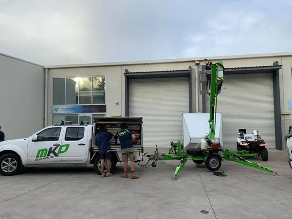 Team Installing Light — Penrith, NSW — MKD Electrical
