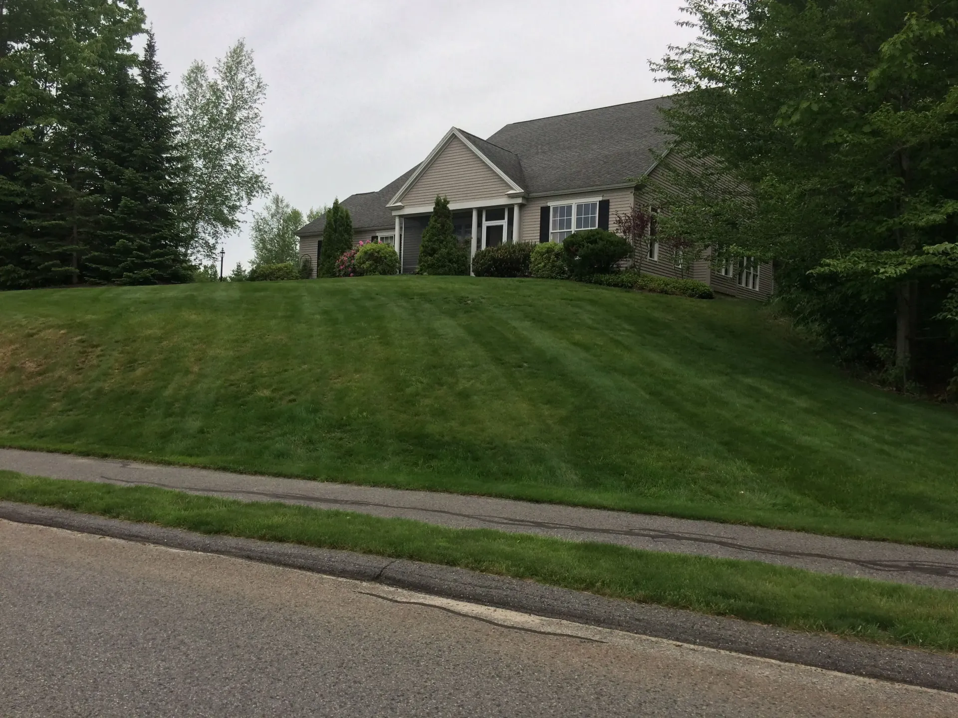 A large house with a lush green lawn in front of it