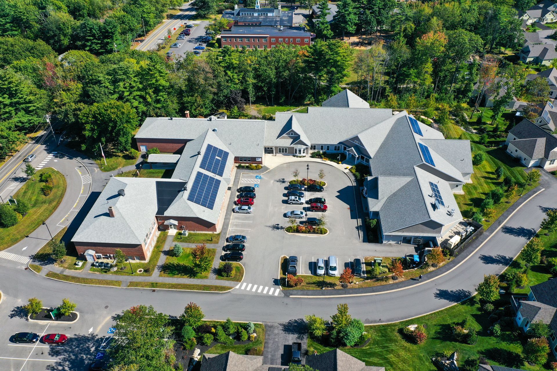 An aerial view of a large building with solar panels on the roof