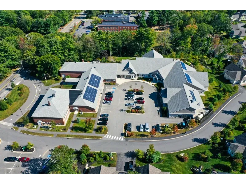 An aerial view of a large building with solar panels on the roof