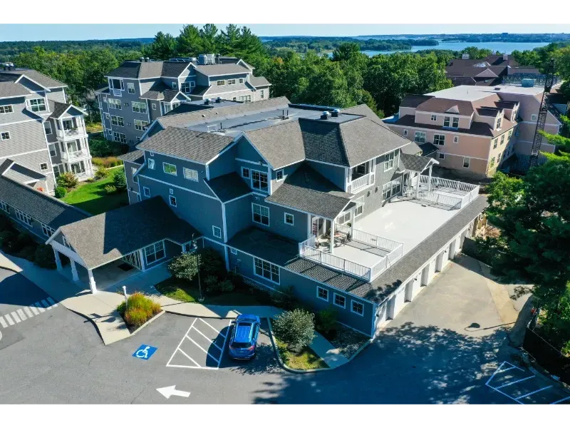 An aerial view of a large building with a car parked in front of it