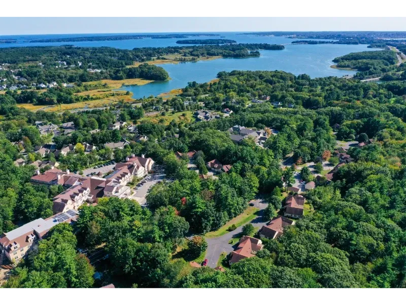 An aerial view of a residential area with a lake in the background