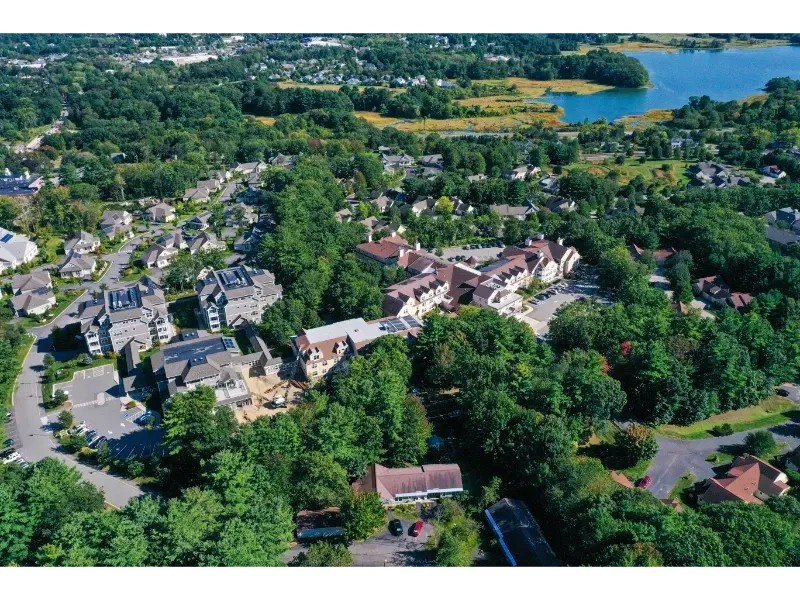 An aerial view of a residential area with a lake in the background