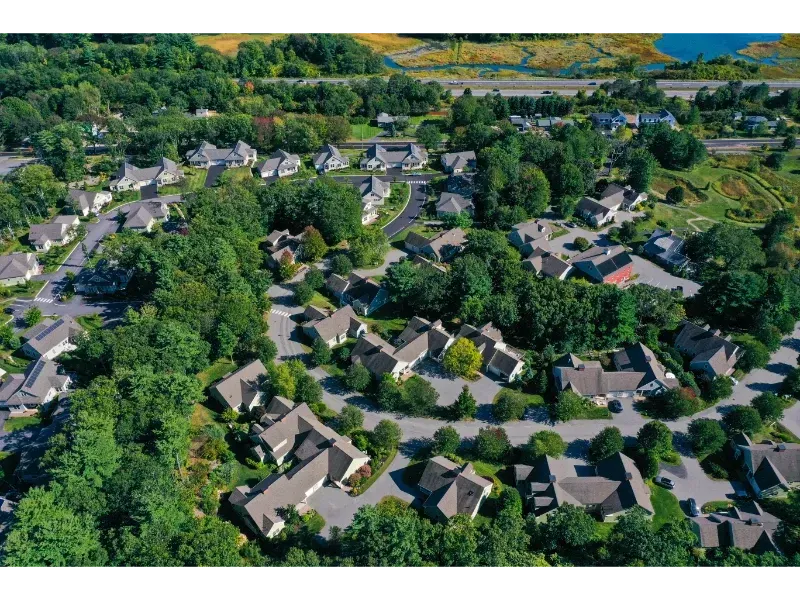 An aerial view of a residential area with lots of trees and houses