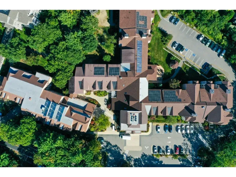 An aerial view of a large building surrounded by trees