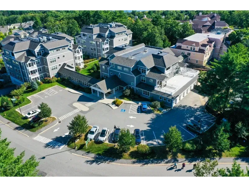 An aerial view of a large apartment complex surrounded by trees